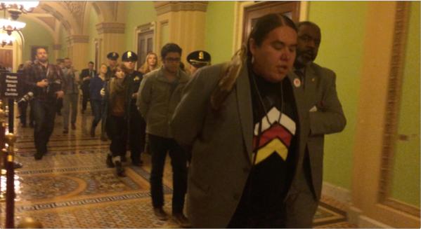 Pic: Protesters are taken away from the Senate chamber after chanting from the gallery following the Keystone vote. Frank Thorp VVerified/Twitter