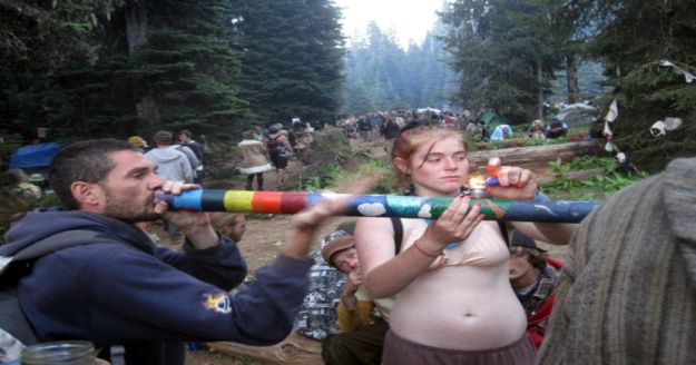 Smoking the giant pipe at a Rainbow Gathering  in Gifford Pinchot National Forest in southern Washington State