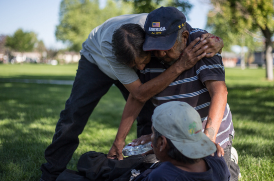 Ben Piper, left, hugged Teddy Goggles, grandfather of the injured James Goggles, at a park in Riverton, Wyo. Many of the people who drink in the parks are Native Americans, according to local officials. Ryan Dorgan for The New York Times