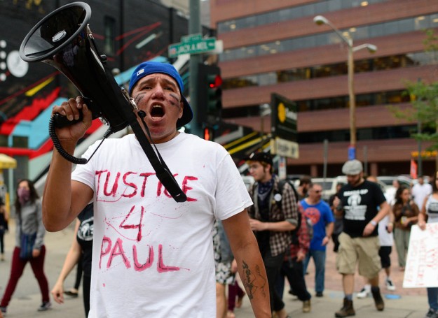 "DENVER, CO - July 14: Thomas Morado, causing of Paul Castaway, leads the march during a protest about the police involved shooting of Paul Castaway on Tuesday, July 14, 2015 along the 16th Street Mall in Denver, Colorado.  (Photo By Brent Lewis/The Denver Post)"
